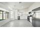 Bright, airy kitchen featuring stainless steel appliances and elegant chandelier with seamless flow to living space at 14398 W Marcus Dr, Surprise, AZ 85374