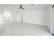 Open-concept living room with high ceilings, tile flooring, and views of the front entry at 14398 W Marcus Dr, Surprise, AZ 85374