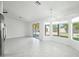 Bright, open living room featuring tile floors, recessed lighting, sliding door, and a modern chandelier at 14398 W Marcus Dr, Surprise, AZ 85374