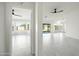 Bright, open-concept living space features sleek tile floors and large windows with backyard views at 14398 W Marcus Dr, Surprise, AZ 85374