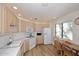 Bright kitchen with white appliances, light wood cabinets, and an eat-in area at 15252 N 100Th St # 2148, Scottsdale, AZ 85260