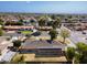 This is an aerial view of a house with solar panels on the roof and a well-kept backyard at 1610 E Mclellan Rd, Mesa, AZ 85203