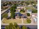Aerial view of the home with a large yard, solar panels, and mature landscaping at 1610 E Mclellan Rd, Mesa, AZ 85203