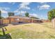 A spacious backyard featuring a brick house, fenced perimeter, and ample lawn space for outdoor activities at 1610 E Mclellan Rd, Mesa, AZ 85203