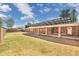 Spacious backyard with a covered patio, brick exterior, and solar panels, perfect for outdoor living at 1610 E Mclellan Rd, Mesa, AZ 85203
