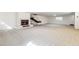 Open basement space with neutral carpet and a tiled fireplace accent wall at 1610 E Mclellan Rd, Mesa, AZ 85203