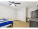 Bright bedroom with tan carpet, ceiling fan, closet, and modern gray dresser at 1610 E Mclellan Rd, Mesa, AZ 85203
