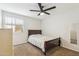 Cozy bedroom with tan carpet, neutral walls, wood-framed bed, and large window at 1610 E Mclellan Rd, Mesa, AZ 85203