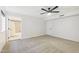 Bright bedroom with a ceiling fan and view into an ensuite bath and closet space at 1610 E Mclellan Rd, Mesa, AZ 85203