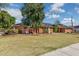 Quaint single story brick house surrounded by a lush lawn and mature landscaping at 1610 E Mclellan Rd, Mesa, AZ 85203