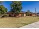 Beautiful red brick home with a well-manicured lawn and decorative brick accents, creating a warm curb appeal at 1610 E Mclellan Rd, Mesa, AZ 85203