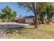 Spacious garage and extra parking featuring mature trees and a well-maintained lawn at 1610 E Mclellan Rd, Mesa, AZ 85203