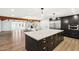 Open concept kitchen featuring a large island, seamlessly connecting to the living area with a cozy fireplace at 1610 E Mclellan Rd, Mesa, AZ 85203