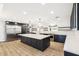 Spacious kitchen features a large island, stainless steel appliances, stylish lighting, and ample countertop space at 1610 E Mclellan Rd, Mesa, AZ 85203