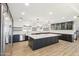 Modern kitchen featuring a large island, stainless steel appliances, custom cabinets, and ample lighting at 1610 E Mclellan Rd, Mesa, AZ 85203