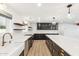 Well-lit kitchen showcasing custom cabinets, subway tile backsplash, stainless steel appliances, and a large kitchen island at 1610 E Mclellan Rd, Mesa, AZ 85203