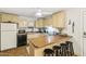 Kitchen featuring light cabinetry, laminate countertops and a breakfast bar with stools at 1610 E Mclellan Rd, Mesa, AZ 85203
