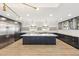 Modern kitchen featuring a large island, stainless steel appliances, custom cabinets, and ample lighting at 1610 E Mclellan Rd, Mesa, AZ 85203