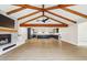 Spacious living room with a fireplace, vaulted ceilings, and modern flooring that flows into the kitchen at 1610 E Mclellan Rd, Mesa, AZ 85203