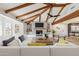 Bright living room with vaulted ceilings, exposed beams, a fireplace, built-in shelves, and a large comfortable sofa at 1610 E Mclellan Rd, Mesa, AZ 85203