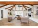 Inviting living room with a fireplace, built-in shelves, vaulted ceilings with exposed beams, and modern neutral decor at 1610 E Mclellan Rd, Mesa, AZ 85203