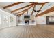 Open living room with high vaulted ceilings, wooden beams, a fireplace, and modern flooring at 1610 E Mclellan Rd, Mesa, AZ 85203