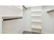 Spacious walk-in closet with built-in shelving and hanging rods for optimal storage at 1610 E Mclellan Rd, Mesa, AZ 85203
