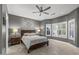 Bedroom with neutral color palette, ceiling fan, and shuttered windows for natural light at 16232 W Montoya Dr, Surprise, AZ 85374