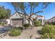 Single-story home featuring desert landscaping and a two-car garage at 16232 W Montoya Dr, Surprise, AZ 85374