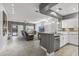 Bright, open-concept living room with a kitchen, tile floors and lots of natural light at 16232 W Montoya Dr, Surprise, AZ 85374