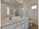 Bright bathroom featuring a dual-sink vanity, large mirror, and walk-in shower at 1713 S 117Th Dr, Avondale, AZ 85323