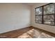 Bright bedroom featuring light wood floors, neutral walls, and a large window offering natural light at 1713 S 117Th Dr, Avondale, AZ 85323