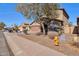 Charming two-story home showcasing a brown exterior, spacious driveway, and drought-resistant landscaping at 1713 S 117Th Dr, Avondale, AZ 85323