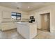 Spacious kitchen with white cabinets, a central island, granite countertops, and black appliances at 1713 S 117Th Dr, Avondale, AZ 85323