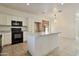 Spacious kitchen with white cabinets, a central island, granite countertops, and black appliances at 1713 S 117Th Dr, Avondale, AZ 85323