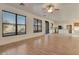 Spacious living room flowing into kitchen, featuring hardwood floors and natural light at 1713 S 117Th Dr, Avondale, AZ 85323