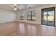 Large living room with light wood floors, ceiling fan, sliding door, and natural light at 1713 S 117Th Dr, Avondale, AZ 85323