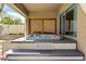 Covered jacuzzi on a tiled platform with privacy lattice at 17741 W Port Royale Ln, Surprise, AZ 85388