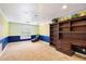 Unique bedroom with a large bookcase and desk area, plus colorful striped walls at 18256 N 75Th Ave, Glendale, AZ 85308