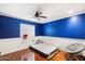Bedroom featuring a mattress on the floor, blue walls with white trim, and a window at 18256 N 75Th Ave, Glendale, AZ 85308