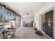 Covered patio featuring a sliding door, white brick walls, and outdoor accessories at 18256 N 75Th Ave, Glendale, AZ 85308