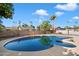 Backyard with pool, palm trees, orange tree and block fencing in residential neighborhood at 18256 N 75Th Ave, Glendale, AZ 85308