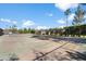 Outdoor tennis court surrounded by a fence and mature trees at 18256 N 75Th Ave, Glendale, AZ 85308