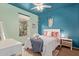 Charming bedroom with a full sized bed, a teddy bear, and teal and aqua walls at 18413 W Paseo Way, Goodyear, AZ 85338