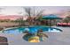 Gorgeous pool and spa with lush desert landscaping and a charming outdoor seating area at 18413 W Paseo Way, Goodyear, AZ 85338