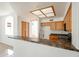 Well-lit kitchen with wooden cabinetry, tiled floors, a breakfast bar, and modern appliances at 2021 N 106Th Ave, Avondale, AZ 85392