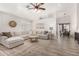 Bright living room featuring tile floors, a large sofa, and access to the dining area at 2083 E Saratoga St, Gilbert, AZ 85296