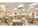 Bright dining room with wood floors, plenty of tables, and a large clock on the wall for a welcoming touch at 2265 Leisure World --, Mesa, AZ 85206