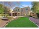 Spacious backyard featuring manicured lawn, covered patio, and a beautiful pool and spa at 2670 E Parkview Dr, Gilbert, AZ 85295