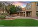 Evening backyard view with lush lawn, pool, spa and covered patio, perfect for outdoor living at 2670 E Parkview Dr, Gilbert, AZ 85295
